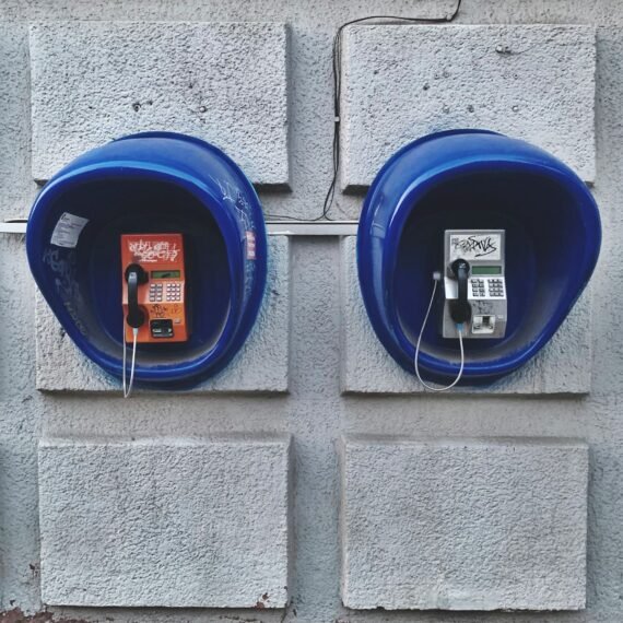 two blue telephone booths on wall