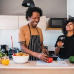 Afro couple cooking together in the kitchen.