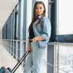 Cheerful attractive young woman travelling by world.