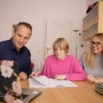woman in blue shirt beside girl in pink shirt