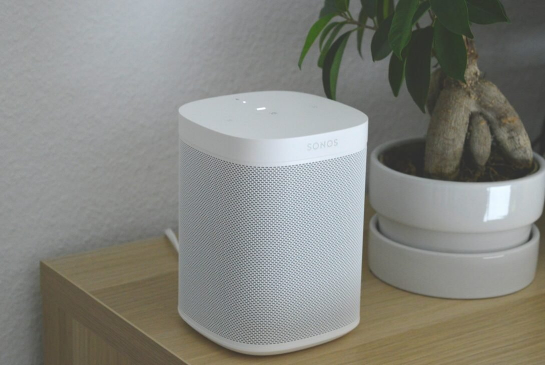 white portable speaker on brown wooden table