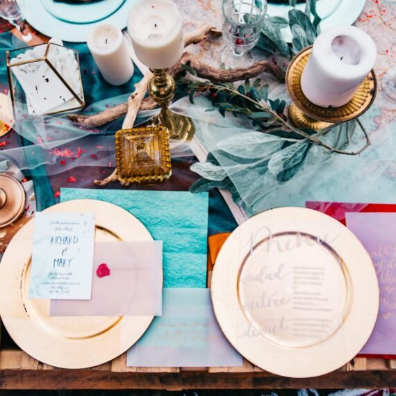 two gold-colored plates on brown wooden table