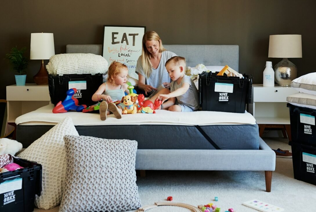 3 children sitting on gray couch
