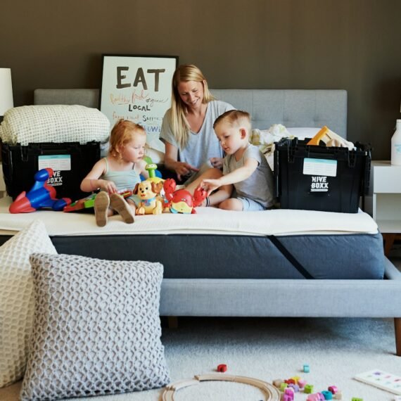 3 children sitting on gray couch