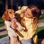 Young woman with dog in park